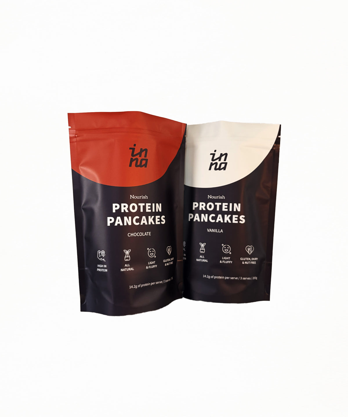 Two stand-up pouches of Inna Protein Pancakes shown on a plain white background. The left pouch is chocolate flavour with a red top section and dark brown lower section.