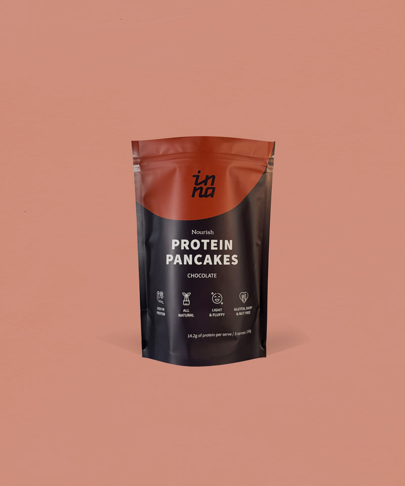 A stand-up pouch of Inna Protein Pancakes in Chocolate flavour, set against a solid terracotta background.