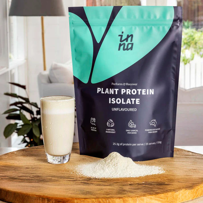 Inna Protein plant protein isolate package with a glass of protein shake on a wooden surface.