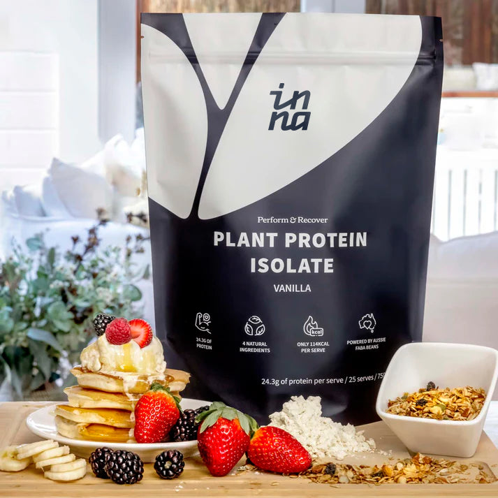 Inna Protein package with a stack of pancakes, berries, and granola on a table.